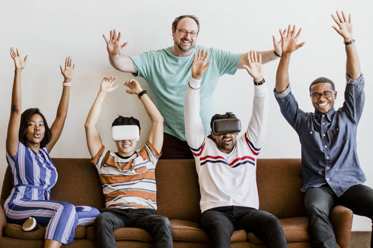 group diverse friends experiencing virtual reality with vr headset scaled e1643994595374
